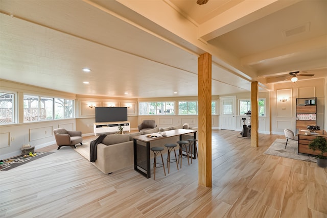 living room with light hardwood / wood-style floors, plenty of natural light, and ceiling fan