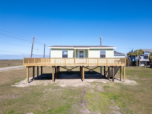 back of property featuring a yard and a wooden deck