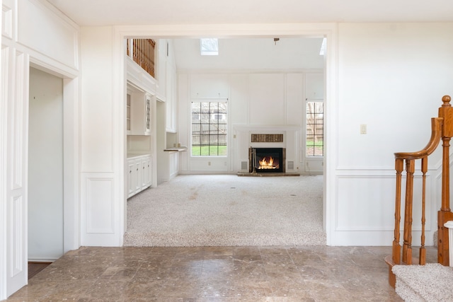 unfurnished living room featuring light carpet