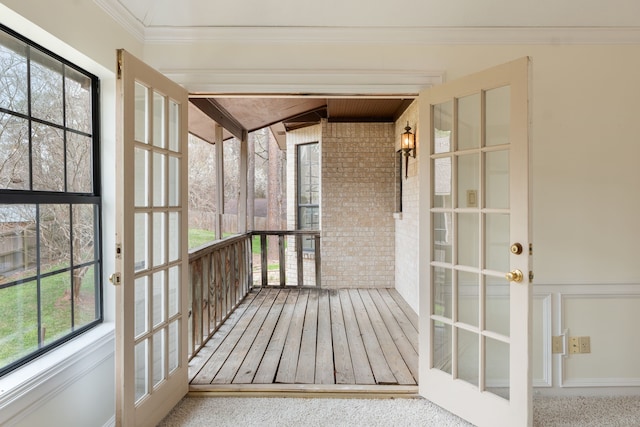 unfurnished sunroom with plenty of natural light and french doors