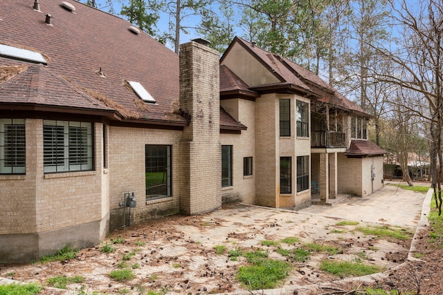 back of property with a balcony and a patio area