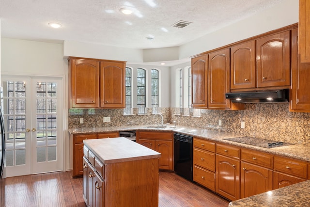 kitchen with backsplash, french doors, dark wood-type flooring, and black appliances