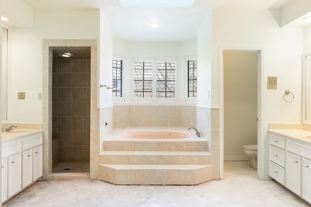 bathroom with toilet, tiled tub, and vanity