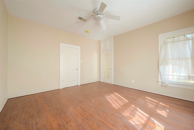 unfurnished room featuring ceiling fan and light wood-type flooring