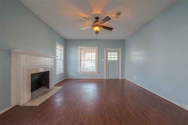 unfurnished living room with a tile fireplace, light hardwood / wood-style floors, and ceiling fan