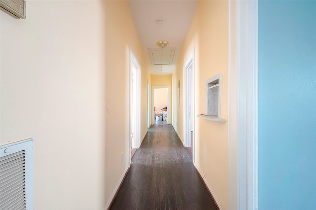 corridor with dark hardwood / wood-style flooring