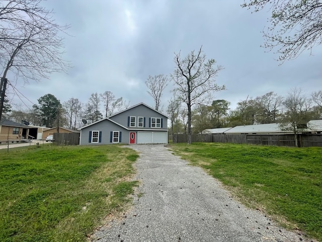 view of front facade with a garage and a front yard