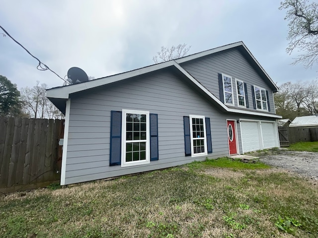 exterior space featuring a lawn and a garage