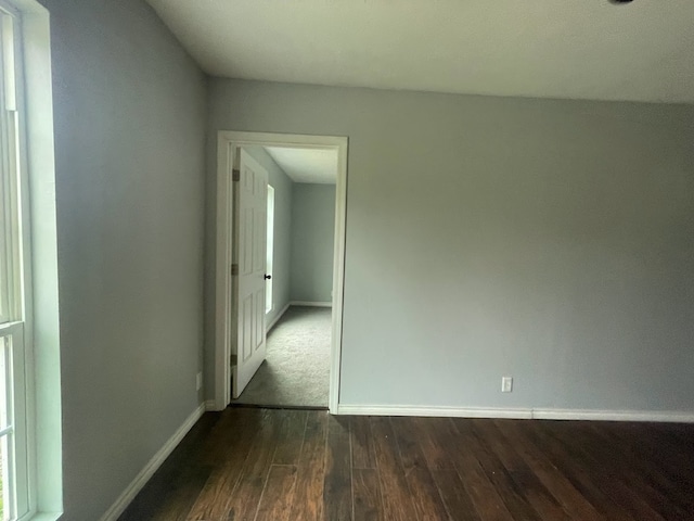 unfurnished room featuring dark hardwood / wood-style flooring