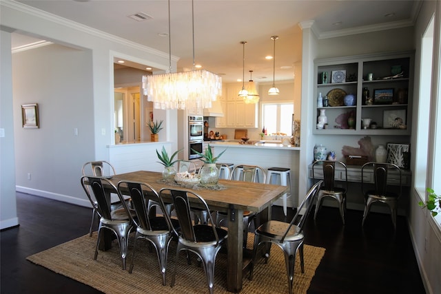 dining room with ornamental molding, dark hardwood / wood-style floors, and an inviting chandelier