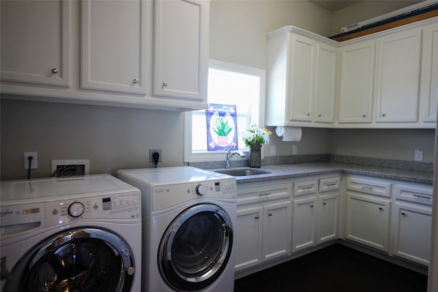 clothes washing area with cabinets, hookup for an electric dryer, hookup for a washing machine, sink, and washing machine and dryer