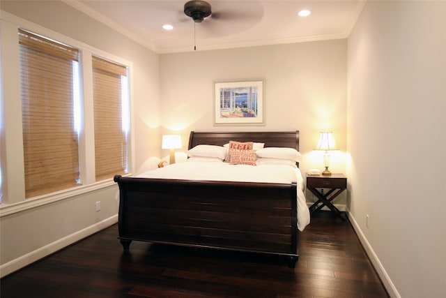 bedroom featuring dark hardwood / wood-style flooring, ornamental molding, and ceiling fan