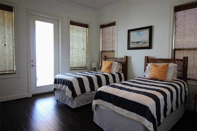 bedroom with dark hardwood / wood-style flooring and ornamental molding