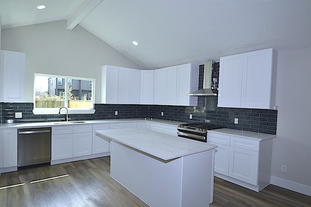 kitchen with backsplash, white cabinets, and appliances with stainless steel finishes