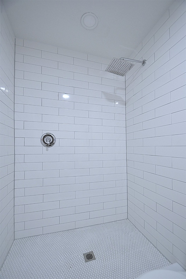 bathroom with tiled shower