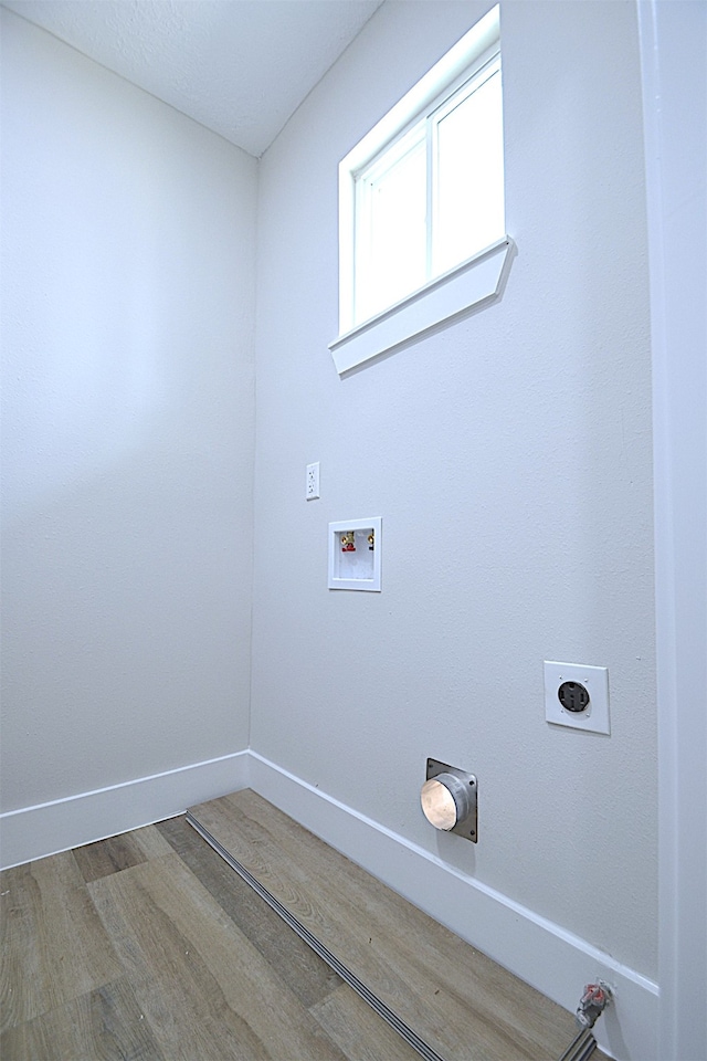 clothes washing area featuring hardwood / wood-style floors, hookup for an electric dryer, and washer hookup