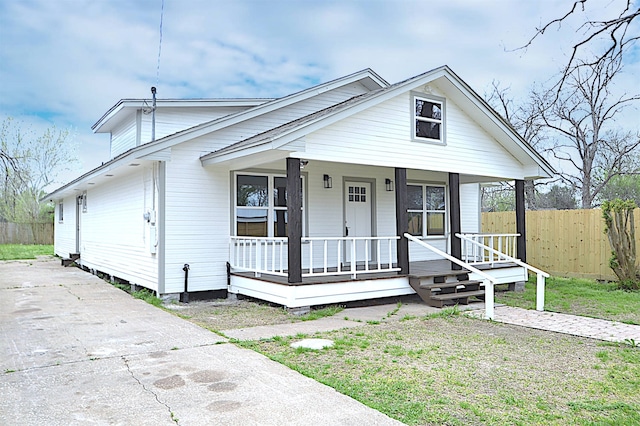 view of front of house with a front yard and a porch