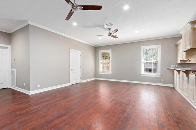 unfurnished living room featuring plenty of natural light, dark hardwood / wood-style flooring, and ceiling fan