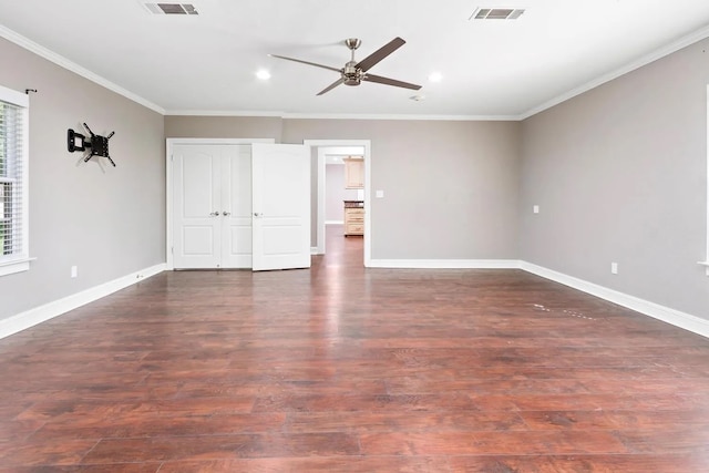 spare room with ceiling fan, ornamental molding, and dark hardwood / wood-style floors