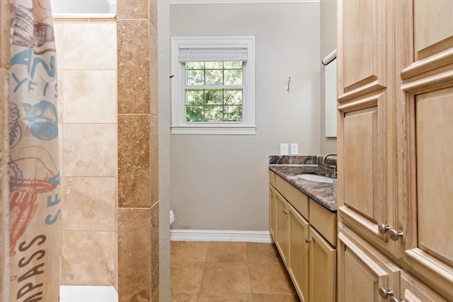 bathroom featuring toilet, tile flooring, and vanity