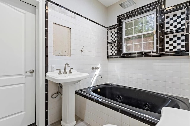 bathroom featuring tile walls, toilet, and tiled tub