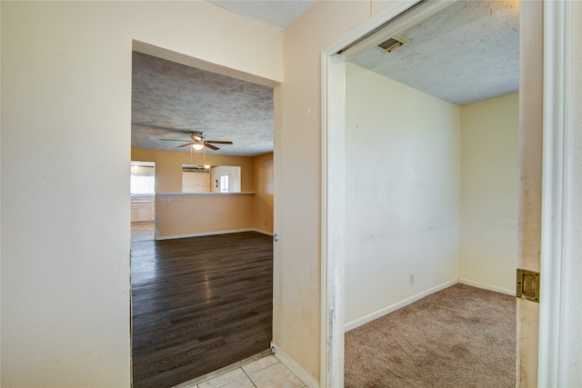 interior space featuring light hardwood / wood-style floors and a textured ceiling