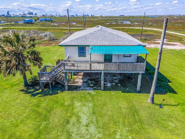 rear view of property featuring a lawn and a deck