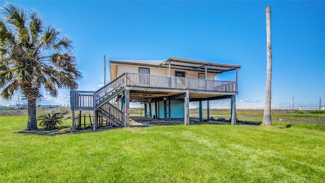 rear view of property with a lawn