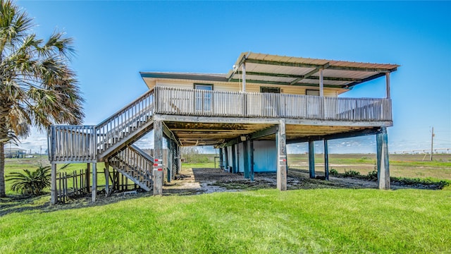 rear view of property with a wooden deck and a yard