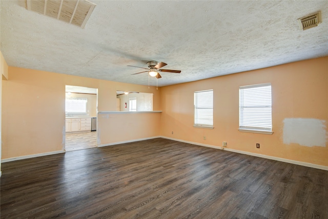 spare room featuring ceiling fan, a textured ceiling, and dark hardwood / wood-style flooring