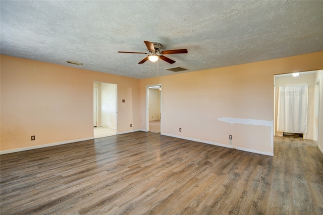 empty room featuring a textured ceiling, ceiling fan, and dark hardwood / wood-style flooring