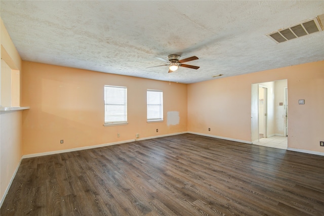 empty room with dark wood-type flooring, ceiling fan, and a textured ceiling