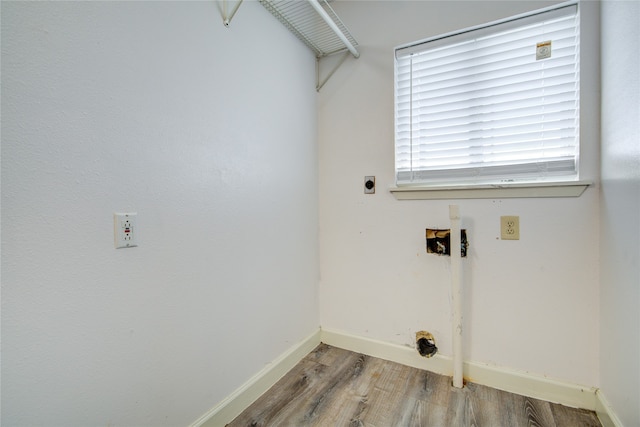 clothes washing area with electric dryer hookup, hardwood / wood-style flooring, and hookup for a washing machine