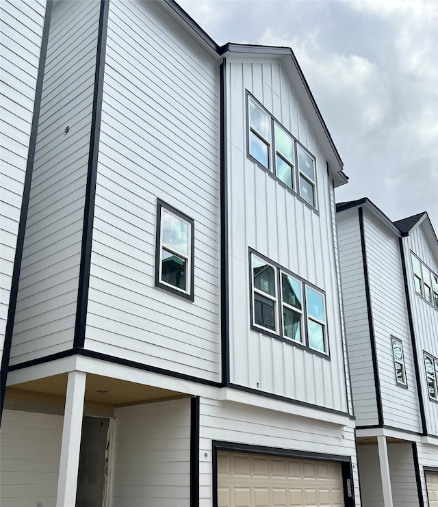 view of side of home featuring a garage