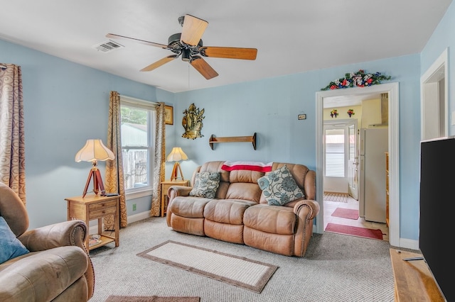 carpeted living room featuring ceiling fan