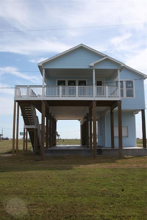 exterior space featuring a wooden deck and a front yard