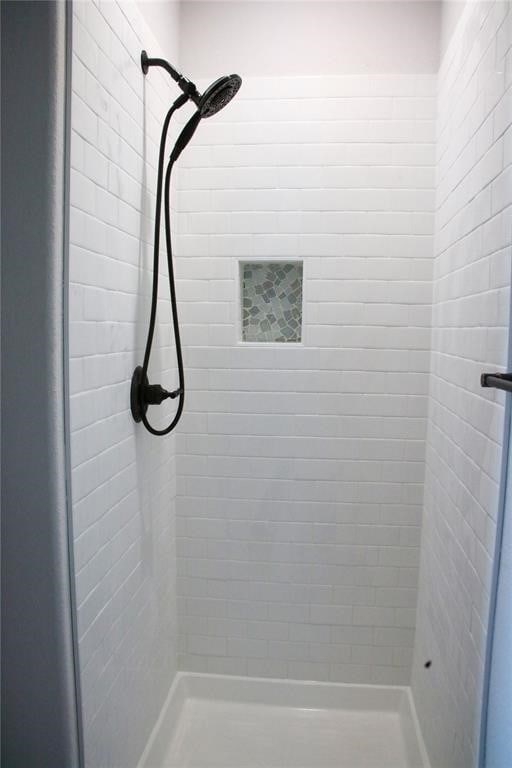 bathroom with tiled shower