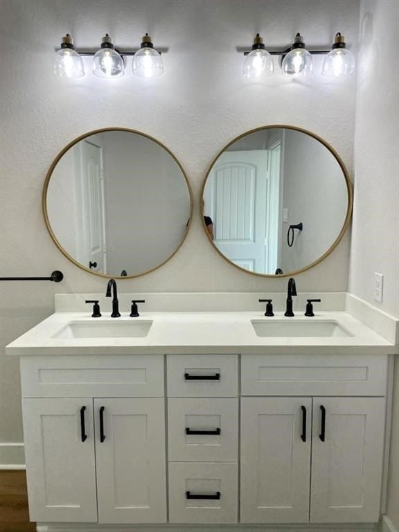 bathroom featuring double vanity and wood-type flooring