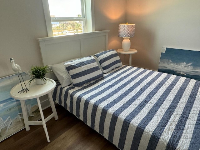 bedroom with dark wood-type flooring