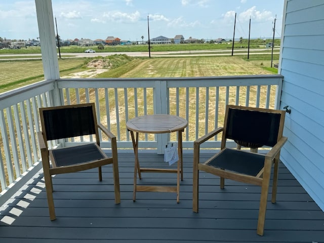 wooden terrace with a lawn