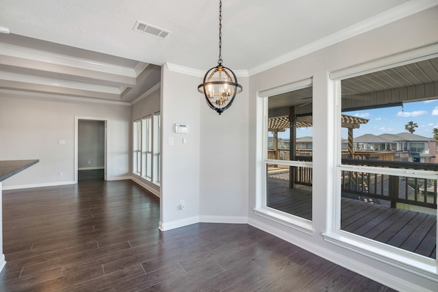 unfurnished room featuring a notable chandelier, crown molding, and dark wood-type flooring