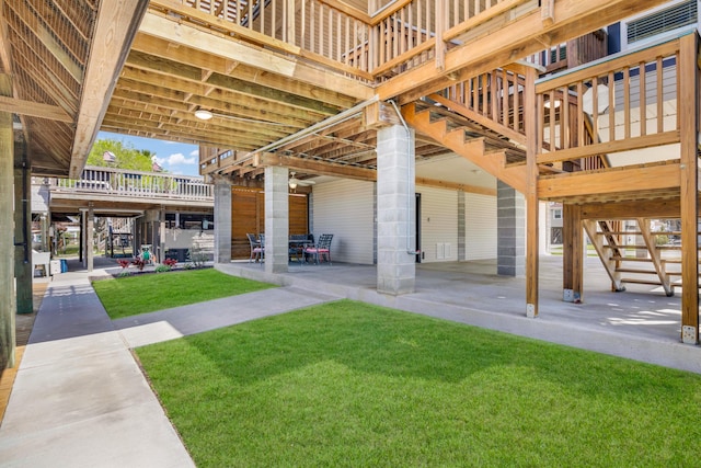 exterior space featuring a patio area, a yard, and a deck