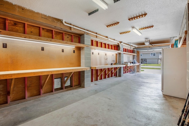 garage featuring a workshop area and a garage door opener