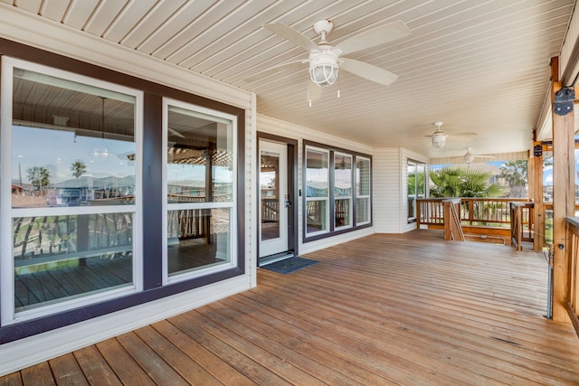 wooden deck featuring ceiling fan