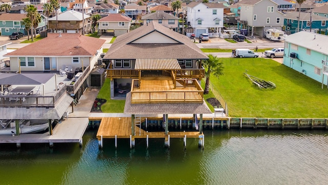 view of dock with a deck with water view and a lawn