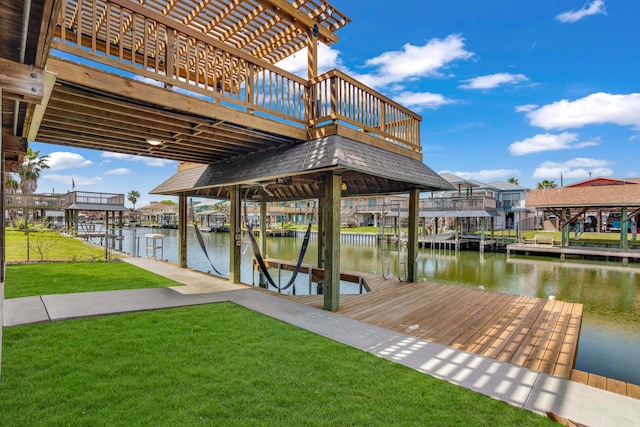 view of dock featuring a water view and a yard