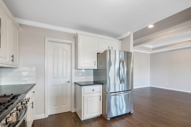 kitchen featuring white cabinets, dark hardwood / wood-style floors, backsplash, ornamental molding, and appliances with stainless steel finishes