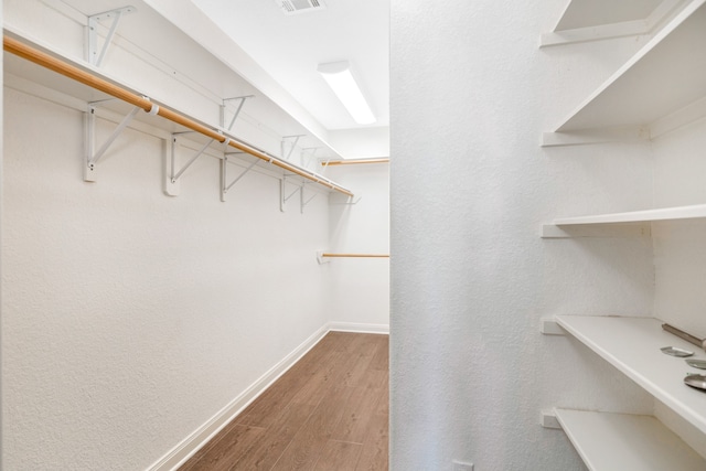 spacious closet featuring hardwood / wood-style flooring