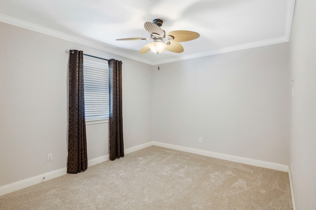 carpeted spare room featuring crown molding and ceiling fan