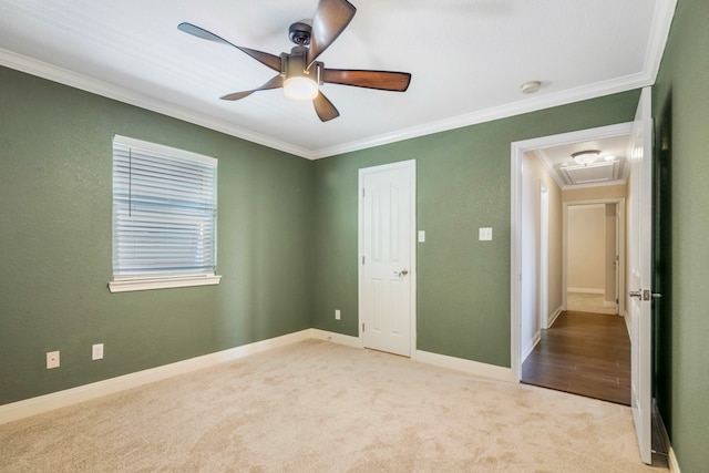 unfurnished bedroom with ceiling fan, carpet flooring, and crown molding